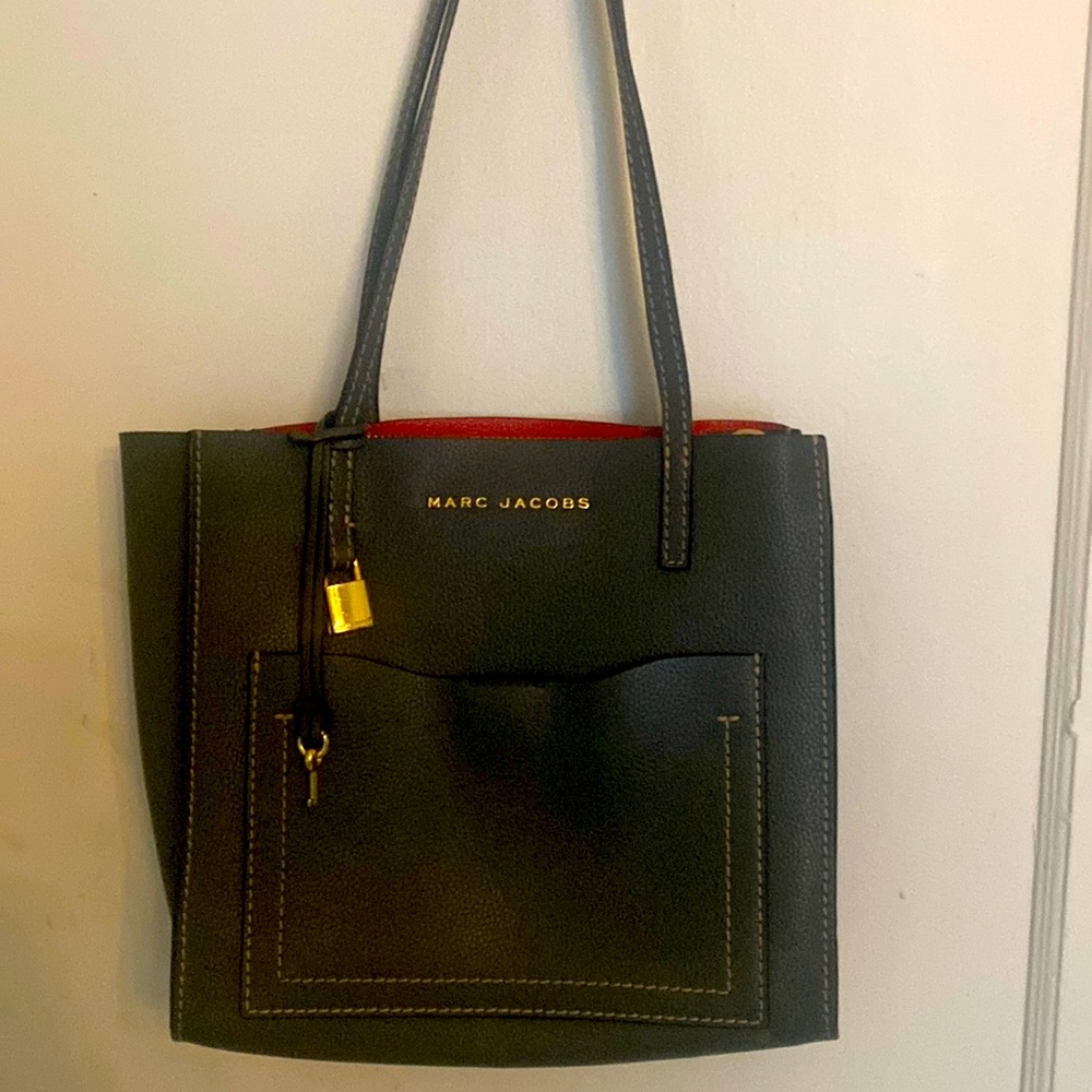 Like new gray leather Marc Jacobs purse with red leather inside. Magnetic pocket